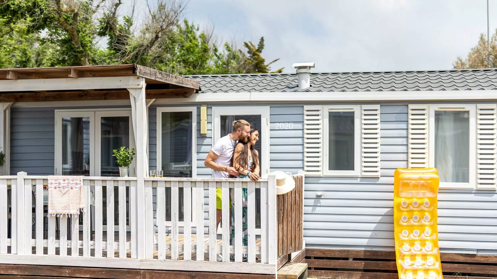 Couple on the veranda of a mobile home at Villaggio San Francesco in Caorle